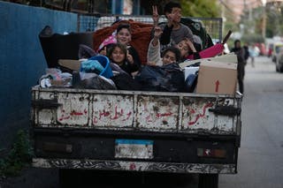 Displaced children sit on a truck with their packed belongings as they wait for an official ceasefire decision between Iran and the United States that they hope will include Lebanon and allow them to return to their villages, in the southern port city of Sidon, Lebanon, Wednesday, April 8, 2026. (AP Photo/Mohammed Zaatari)